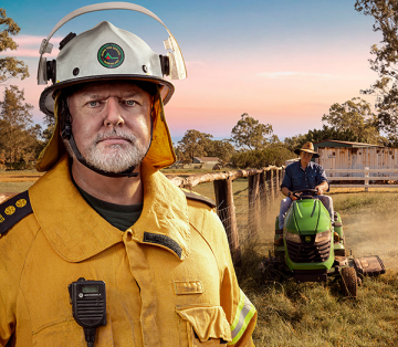 RFSQ firefighter standing while a person is riding a lawn mower, preparing their home for bushfires