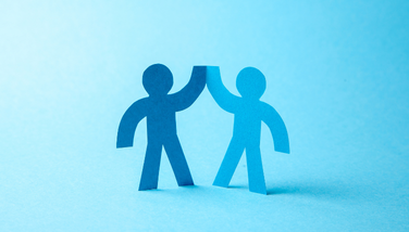 A cartoon of two paper hands high fiving