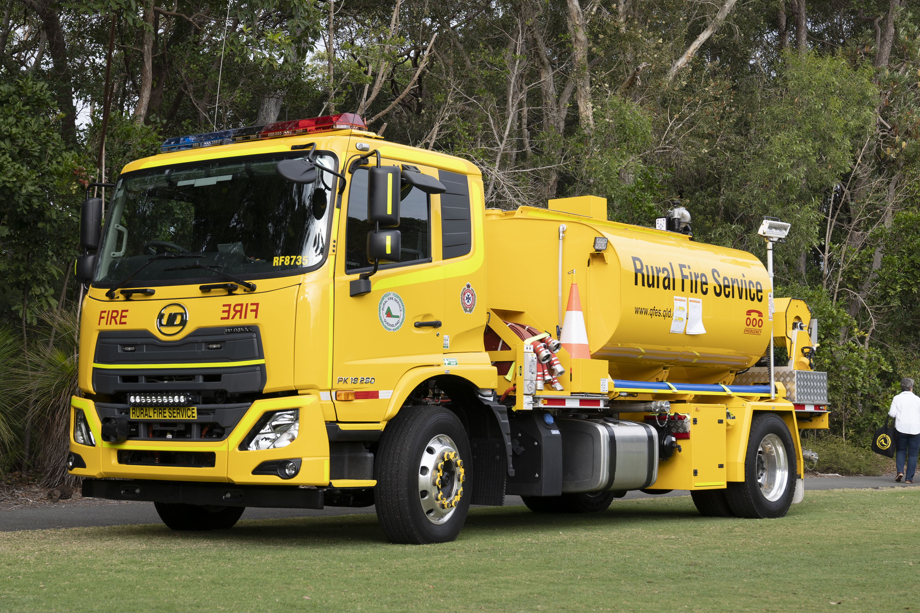 A yellow Rural Fire Service tanker parked on a field.