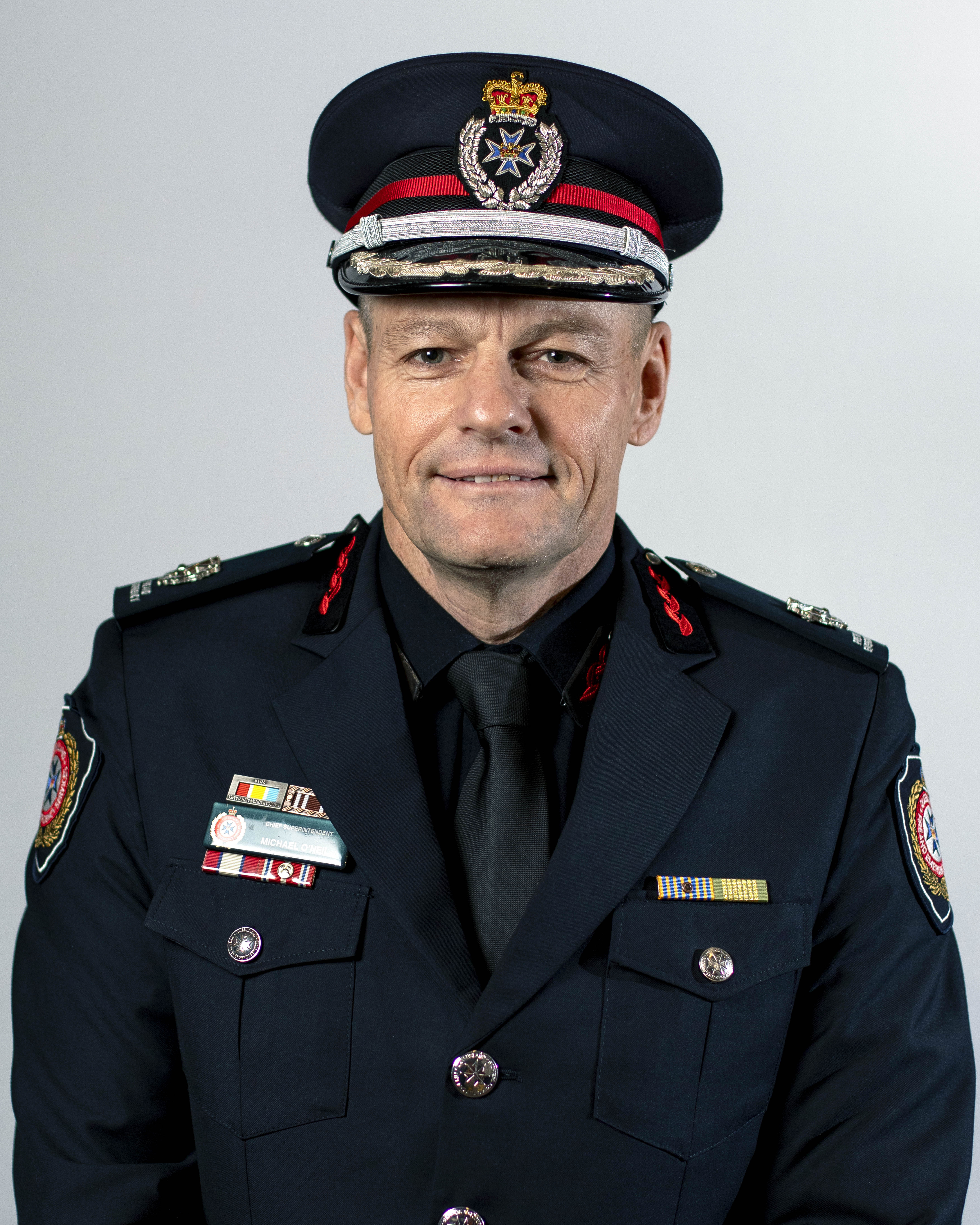 Image of Kevin Walsh wearing uniform and smiling.